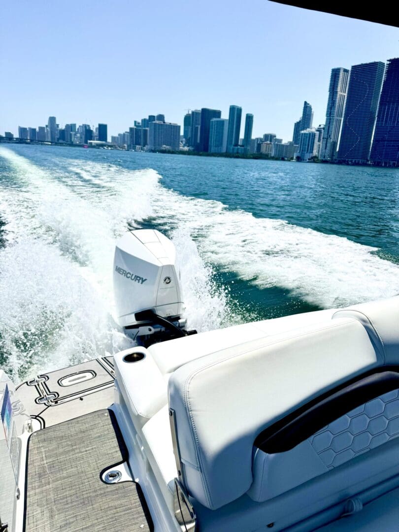 Boat on water with city skyline background.